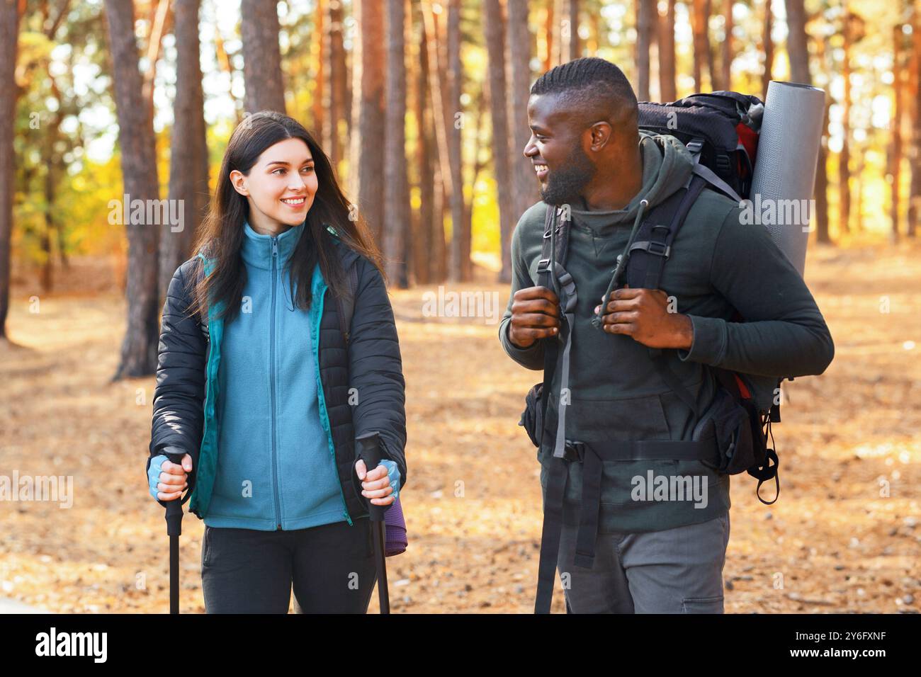 Multiracial group of hikers having fun while backpacking at forest Stock Photo