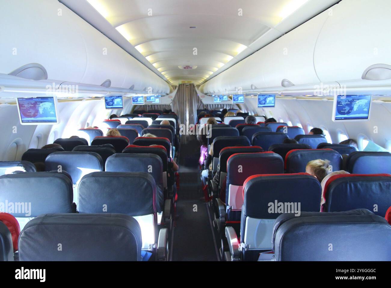 Airplane interior, people sitting on seats Stock Photo