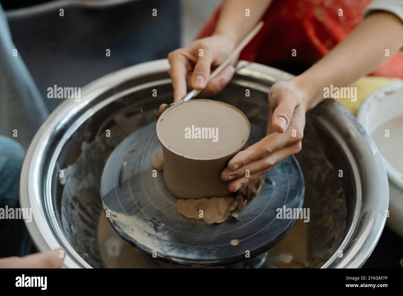 Creating Potery Creating pottery on a wheel in an art studio during daylight hours ...