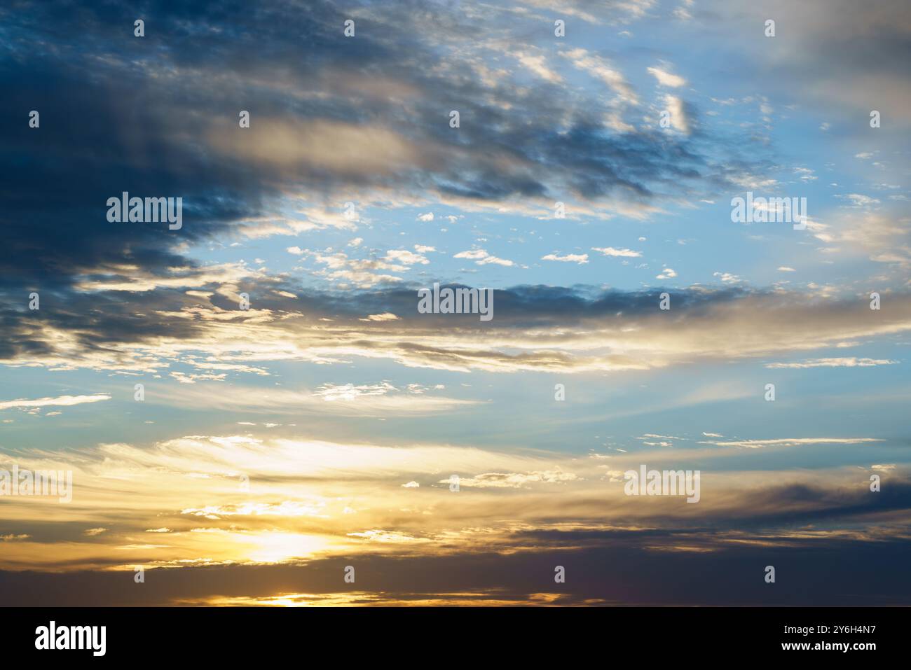 Sunlight piercing through dramatic clouds at sunrise or sunset Stock ...