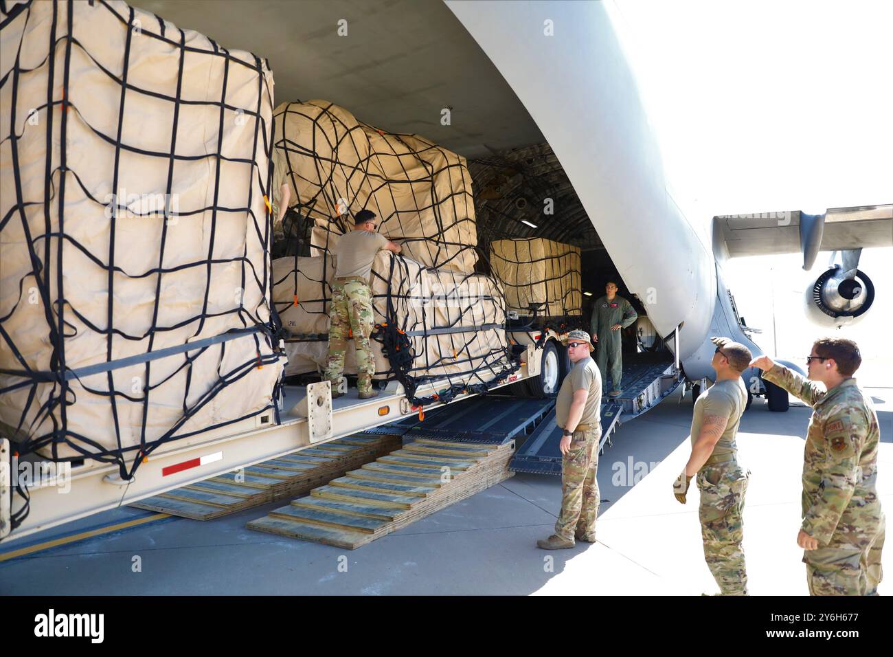 Airmen supervise a M983A4 Light Equipment Transport’s (LET) towing a Land-based Phalanx Weapon System (LPWS) onto a C-17. The LPWS is an integral part of the Counter-Rocket, Artillery and Mortar (C-RAM) system that has kept U.S. and coalition troops safe from attacks for several years. Stock Photo