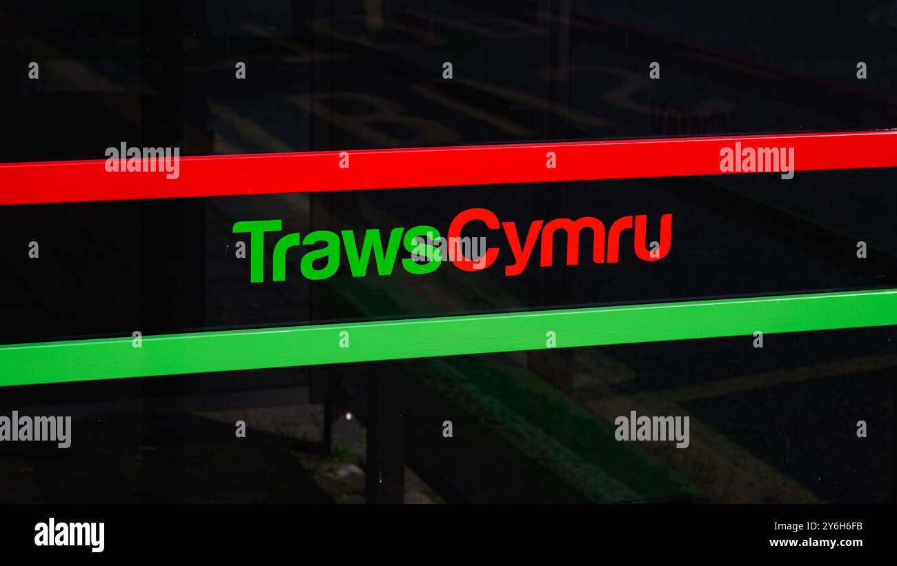 Machynlleth, Wales, UK - September 6, 2024; Green and red sign for Welsh regional bus company TrawsCymru Stock Photo