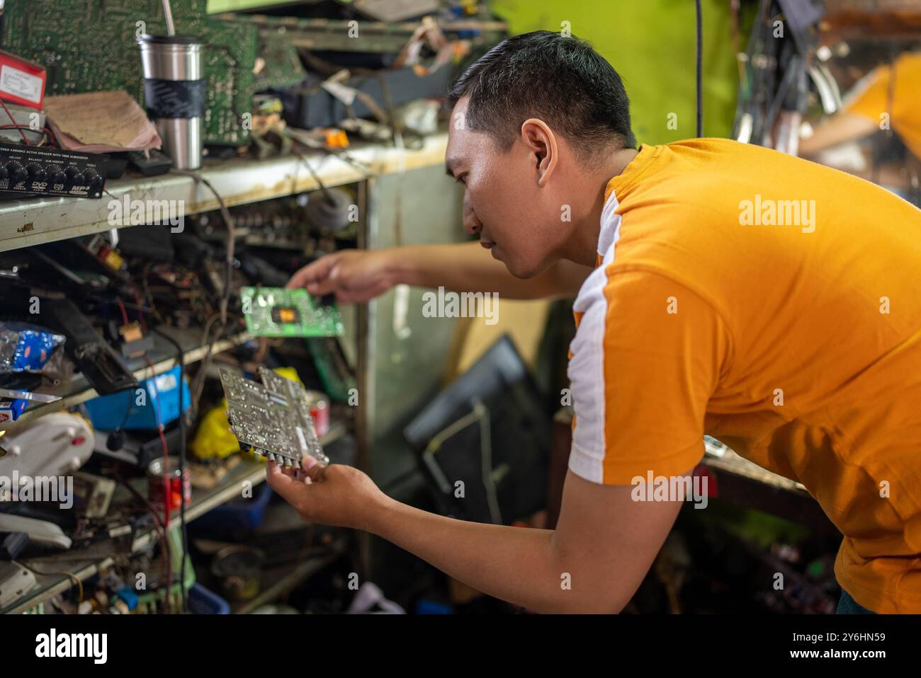technicians view and compare printed circuit boards when replacing electronic circuits Stock Photo