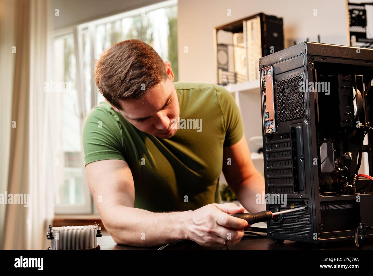 Man assembles a computer system unit at home Stock Photo