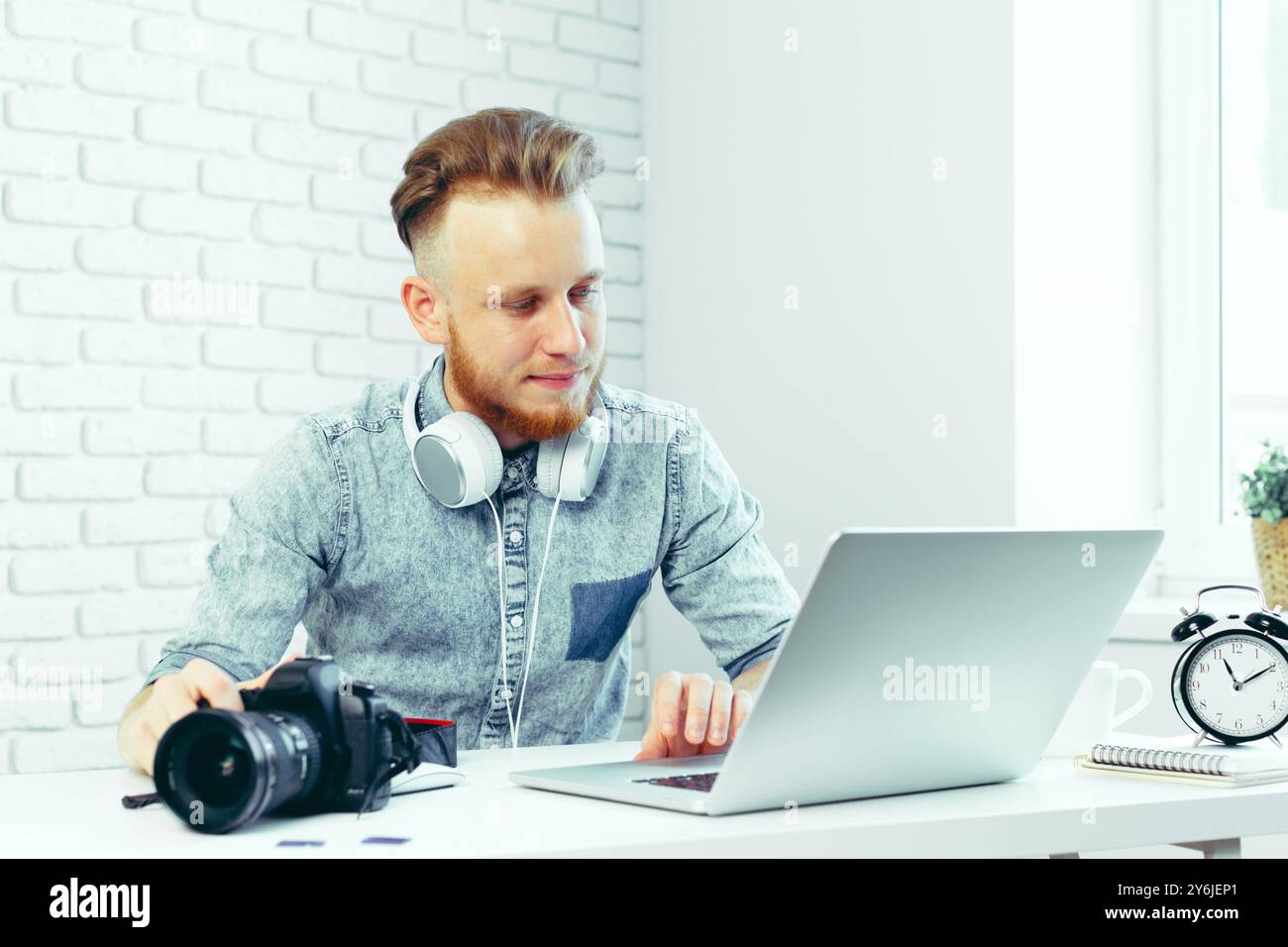 Photographer selecting photos on his computer Stock Photo