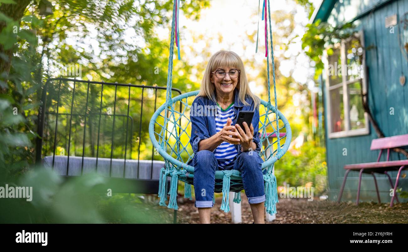 Mature woman summer swing hi-res stock photography and images - Alamy