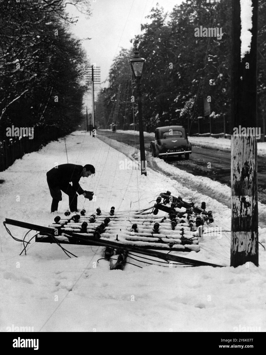 Snow cuts telephone line this image taken at Keston shows one telegraph pole broken off - it was one of several in this district. 26/4/50 Stock Photo