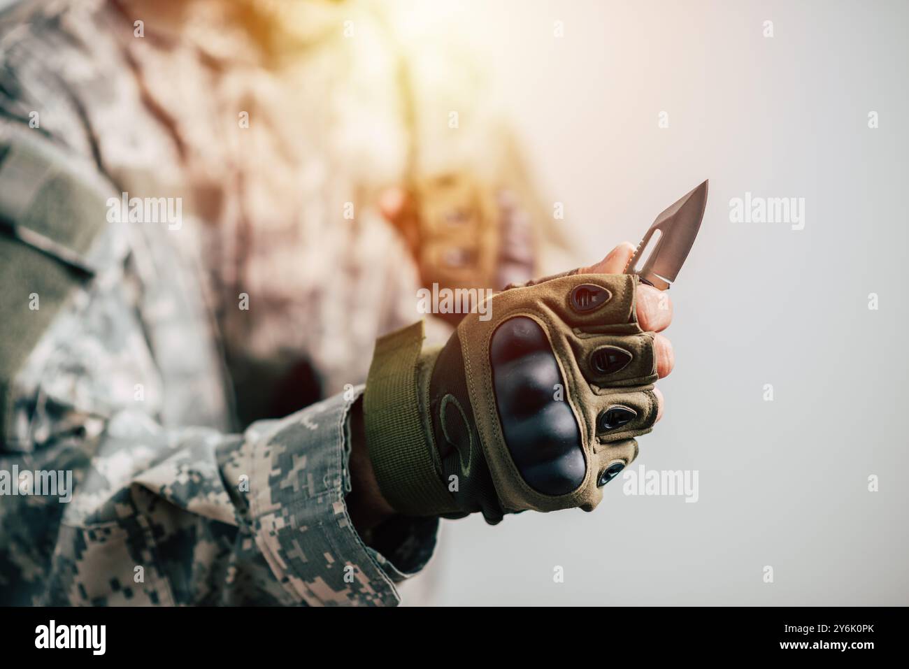 The man wearing tactical gloves using the mini knife. Stock Photo