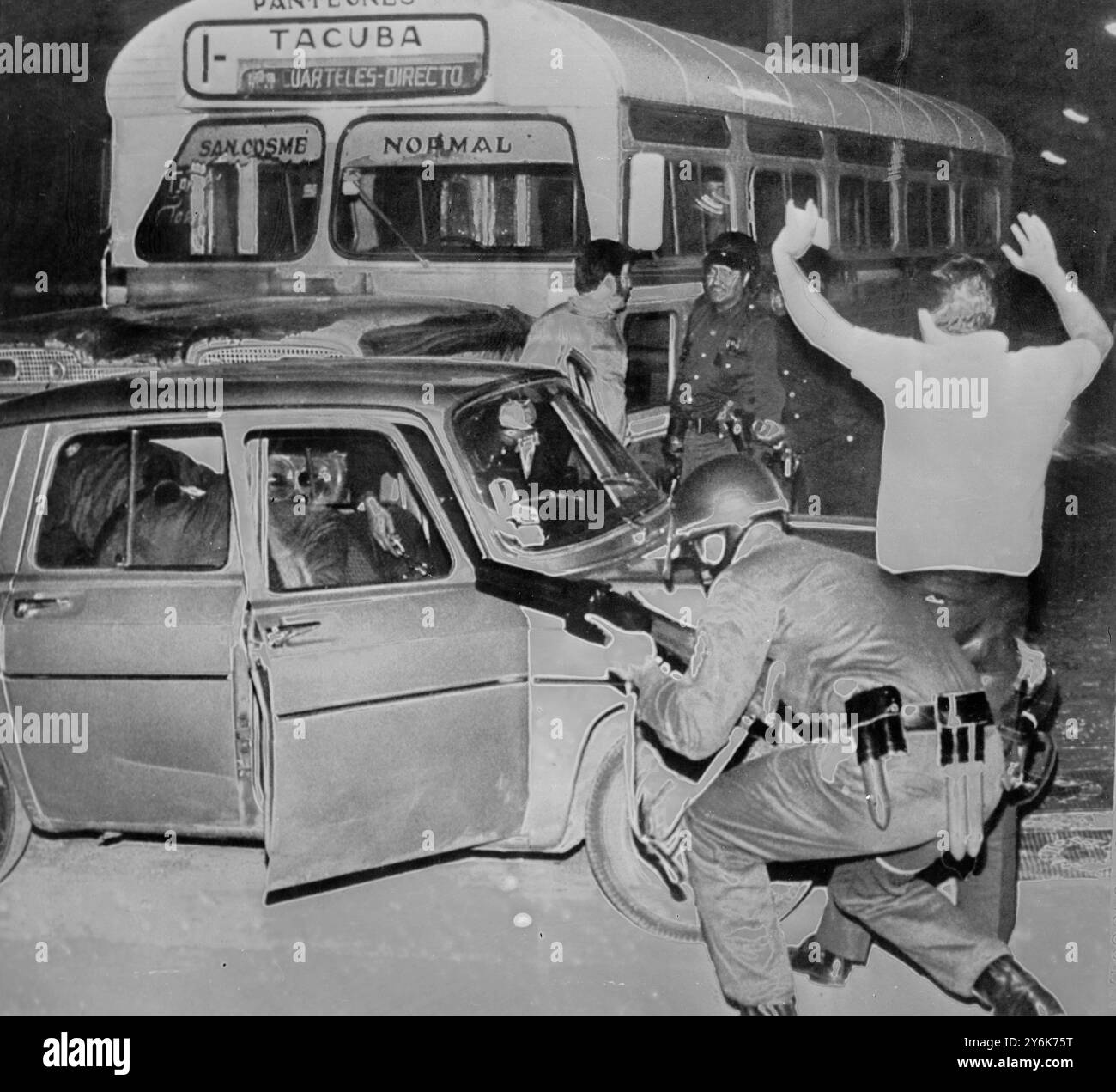 Mexico City Youth has hands up surrendering a soldier stoops to miss sniper fire .  Struggle against the Government of President Ordaz .  riot cast a shadow over the 1968 Olympic Games scheduled to open here 12 October .  24 September 1968 Stock Photo