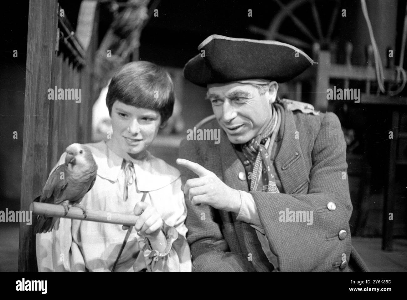 Sitting on his perch is Jack Spratt the parrot actor who plays Captain Flint in the Mermaid Theatre's production of Treasure Island with John Woodvine who plays The Wily Long John Silver and young Sean Scully the cabin boy hero of the piece Jim Hawkins 12 December 1961 Stock Photo