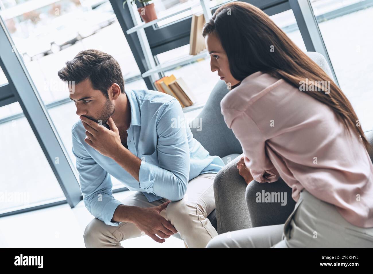 Feeling frustrated. Young married couple solving their issues while ...