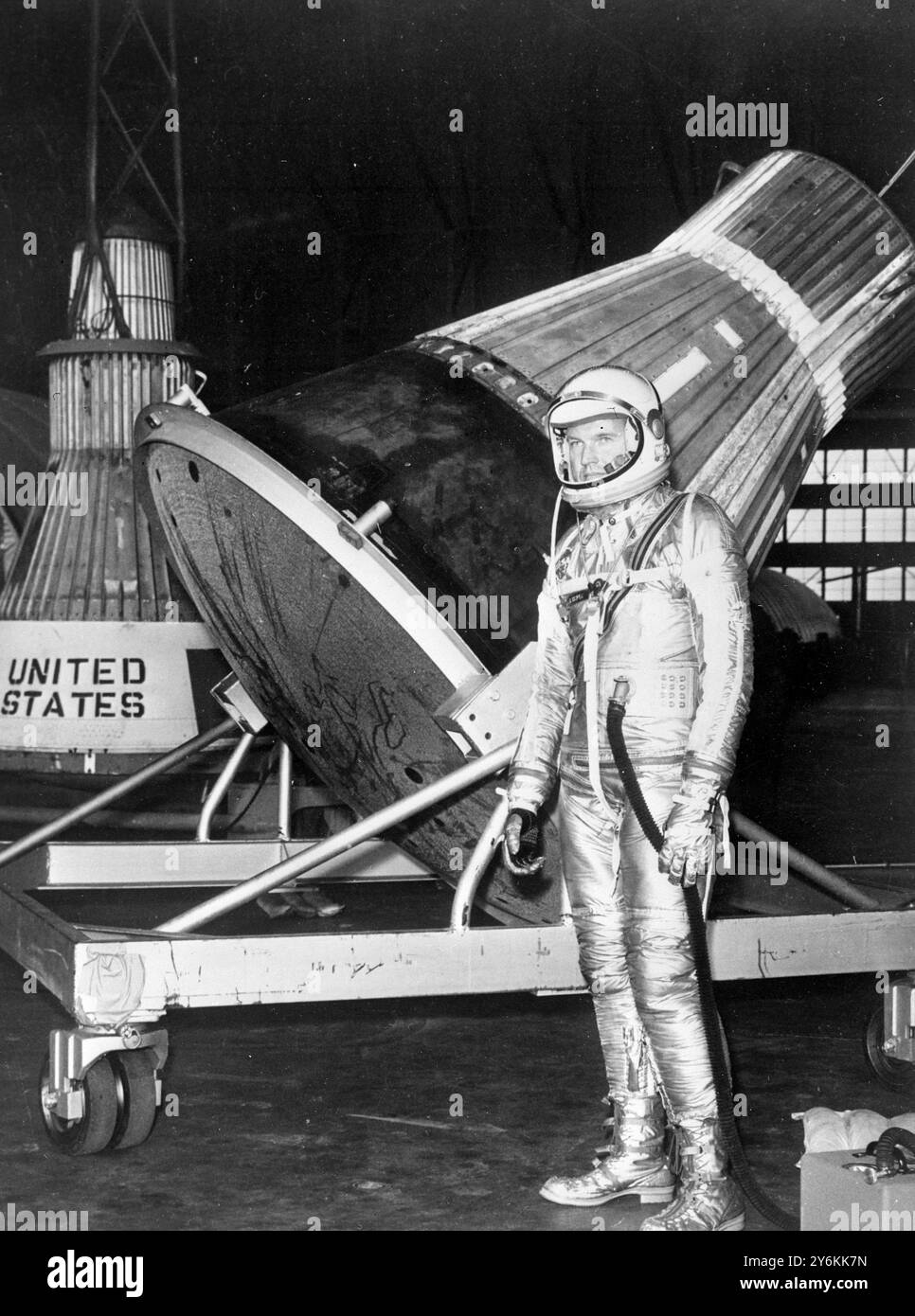 Langley Field, VA: Wearing an aluminiumized space suit, Mercury Astronaut L. Gordon Cooper of Carbondale Colo., stand near a project Mercury Capsule at Langley Field recently, The capsule, and another seen in background, are prototypes of the one in which Cooper or one of the six astronauts will ride into space next year. 3 October 1960 Stock Photo