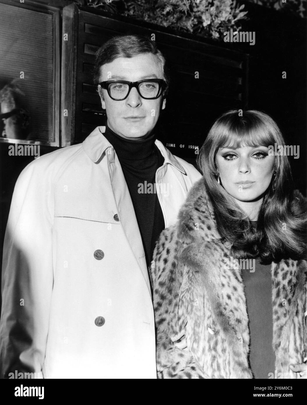 London: Cockney Actor Michael Caine and French Actress Elizabeth Ercy are pictured arriving for the Gala Premiere tonight, of Britain's official entry for the Cannes film Festival, 'Alfie.'. 'Alfie' follows the romantic adventurers of an amoral Cockney who collects 'Birds' the way other men collect stamps. Michael Caine, a Cockney himself, plays the title role.  24 March 1966 Stock Photo