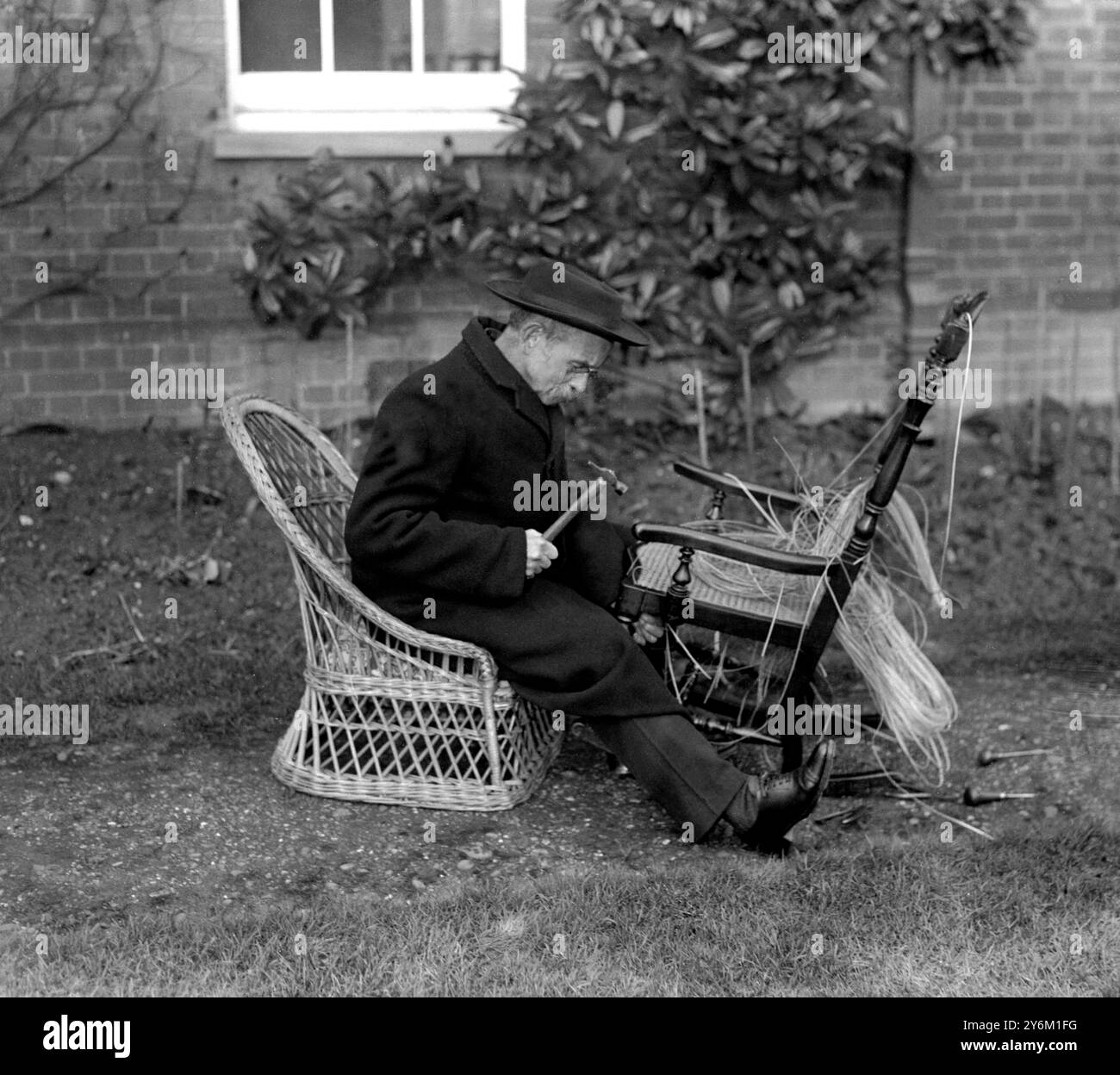 The Reverend T. Smith, vicar of St John's, Harrow, re-bottoming chairs ...