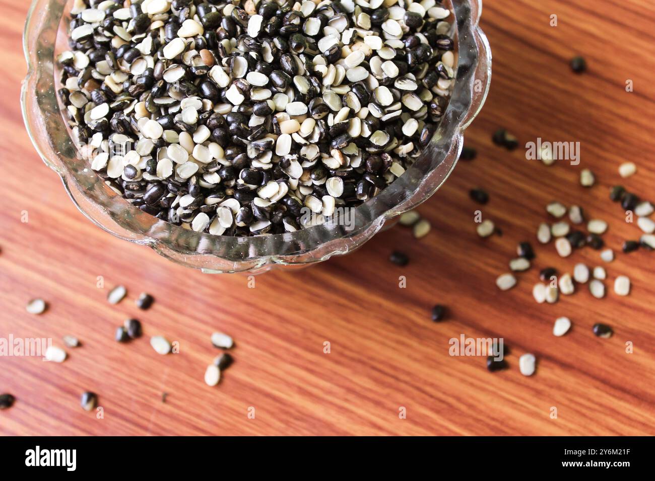 Split Black Lentil Also Know as Black Gram, Black Urad Dal, Vigna Mungo, Urad Bean on brown wooden Background Stock Photo