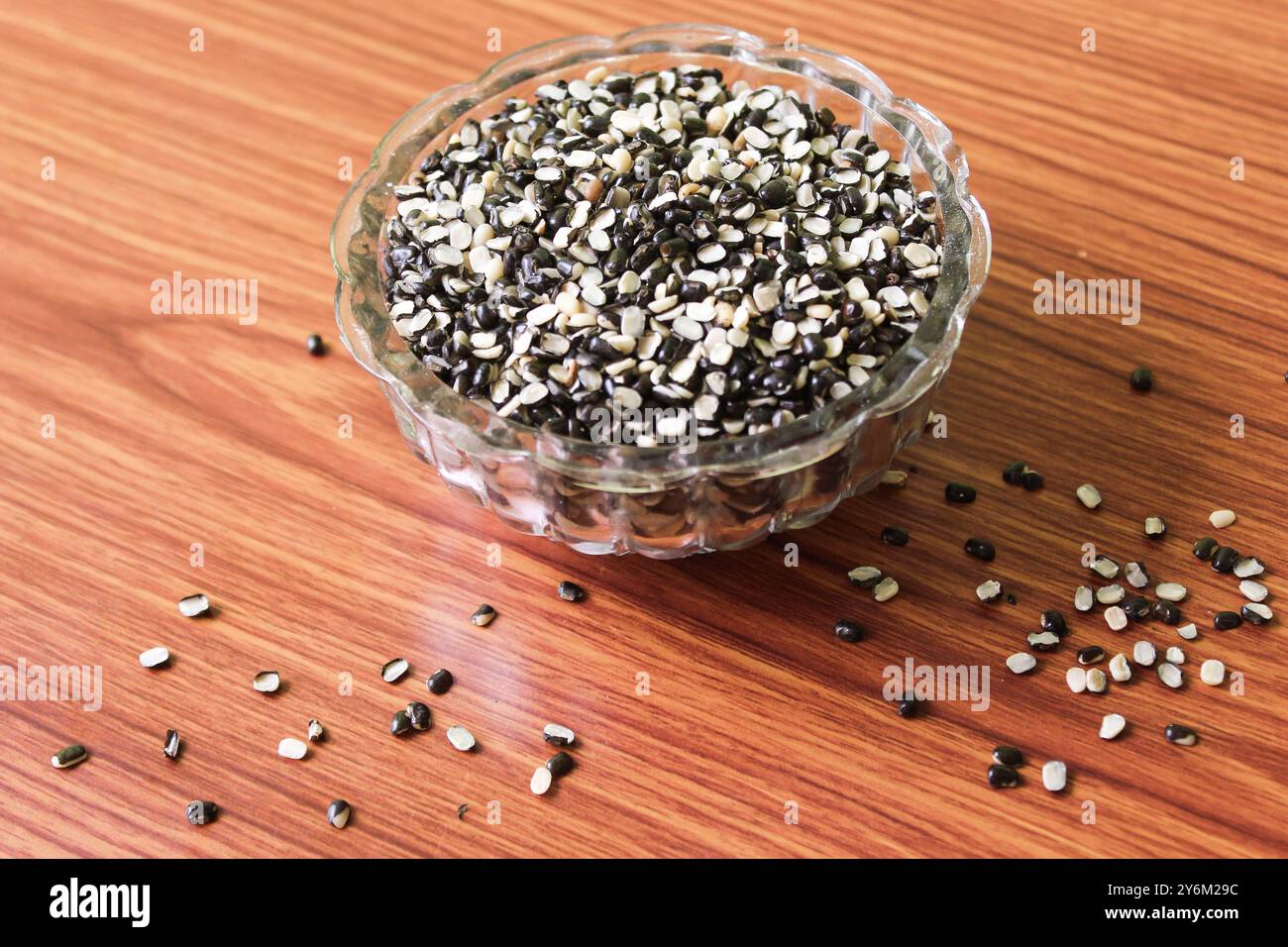 Split Black Lentil Also Know as Black Gram, Black Urad Dal, Vigna Mungo, Urad Bean on brown wooden Background Stock Photo