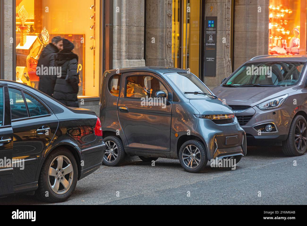 Cart, parked the other way between two cars. Stock Photo