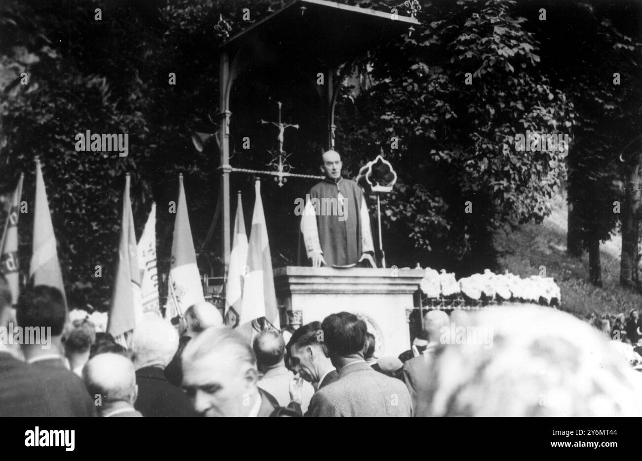Lourdes France: Archbishop John Charles MacQuaid, leader of a group of Irish pilgrims who arrived here by air from Dublin, addresses the pilgrim on from t of the Bernadedtte Grotto, Lourdes. 18 August 1952. Stock Photo