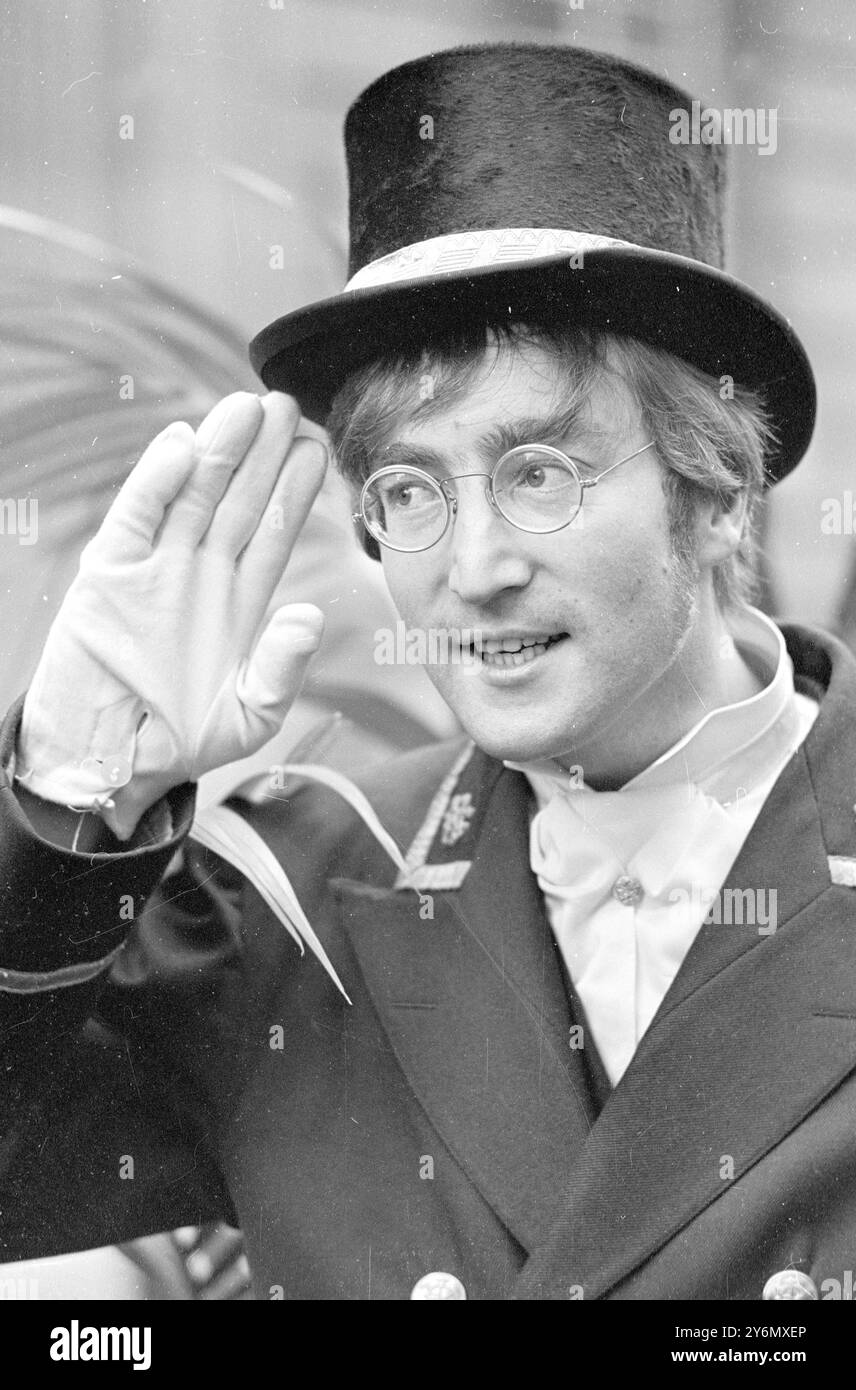 London : Top-Hatted, wearing steel-framed spectacles, and sprucely garbed in a commissionaire's outfit -- This is how Beatles John Lennon will appear in the TV Film, 'Not Only,' But also Location shots of which were made in Soho, London, today, for the programme's Yuletide Spectacular on B.B.C. Television. The film also stars TV Comedian Peter Cook and Dudley Moore. 27 November 1966 Stock Photo