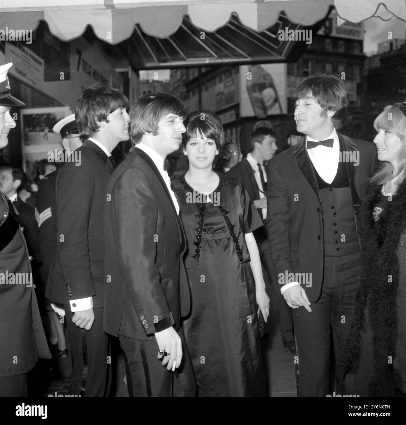 London : London Pavilion this evening where their second movie got off to a flying start with a Royal World Film Premiere, attended by Princess Margaret and the Earl of Showdown left to right Paul McCartney; Ringo Starr with his mother-to-be wife, Maureen;  John Lennon and his wife Cynthia.  George Harrison is not shown.  29th July 1965 Stock Photo