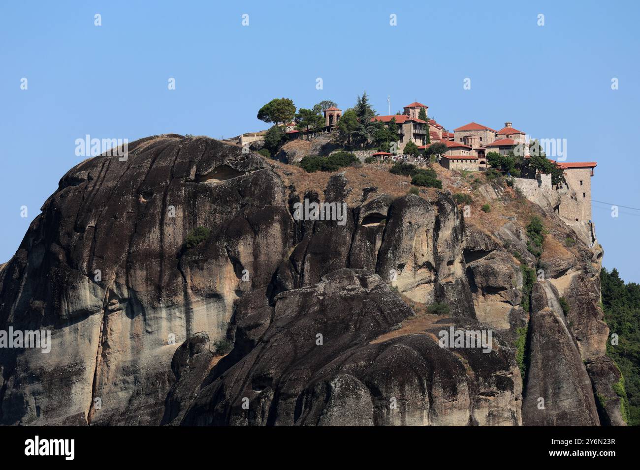 A scenic view of the Meteora monasteries perched on top of rocky cliffs ...
