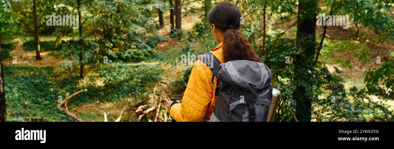 Image showcasing A young woman explores the beauty of a forest in autumn, immersed in ...