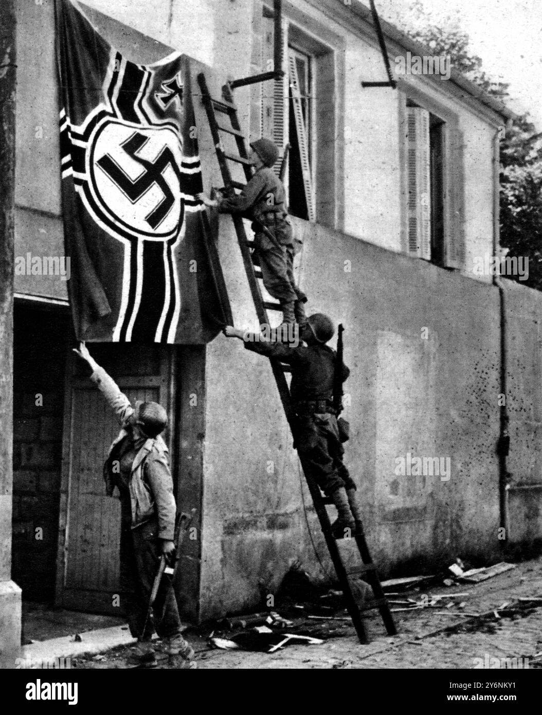 Infantrymen who had fought their way into the strongly defended town of Brest, are seen pulling down a Swastika flag from a building used as a German officers club September 1944  ©2004 Topfoto Stock Photo