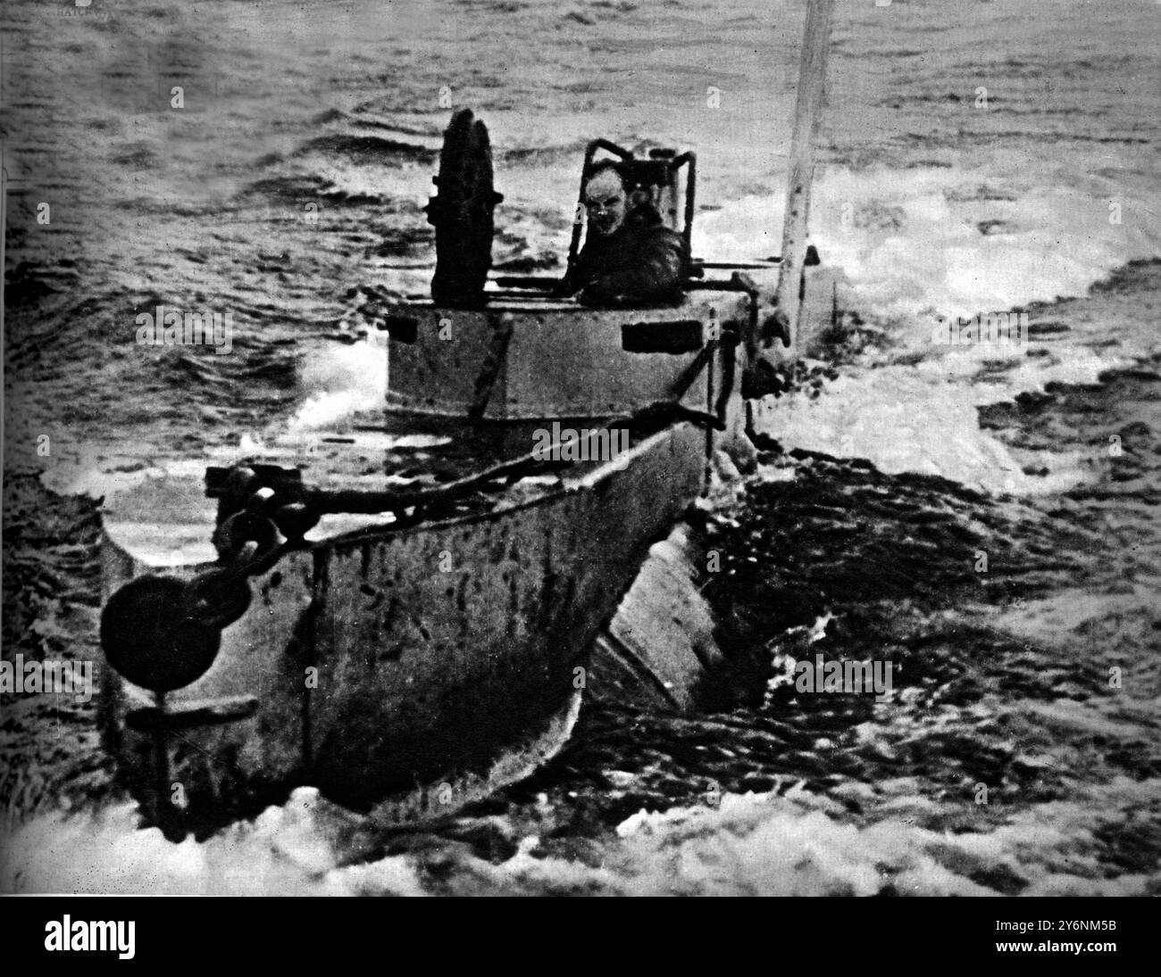 Britains Midget Submarines, similar to those that damaged the German battleship Tirpitz The midget under way with one of her crew at the open hatchway  ©2004 Topfoto Stock Photo