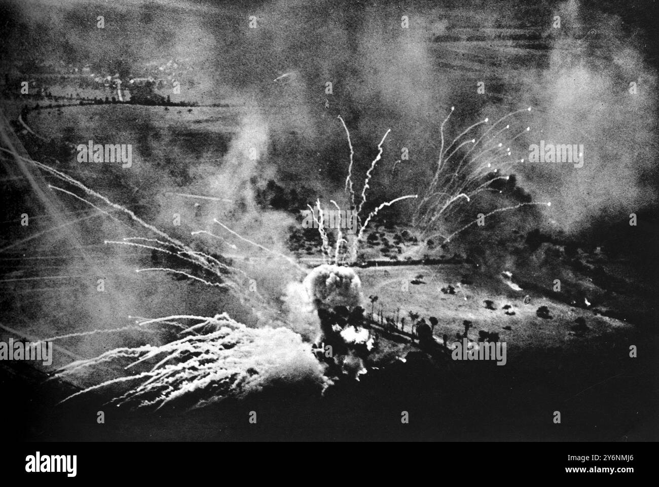 An enemy ammunition dump exploding, showering burning particles far over the countryside. A direct hit during a mass daylight attack by heavy bombers near Falaise August 1944  ©2004 Topfoto Stock Photo