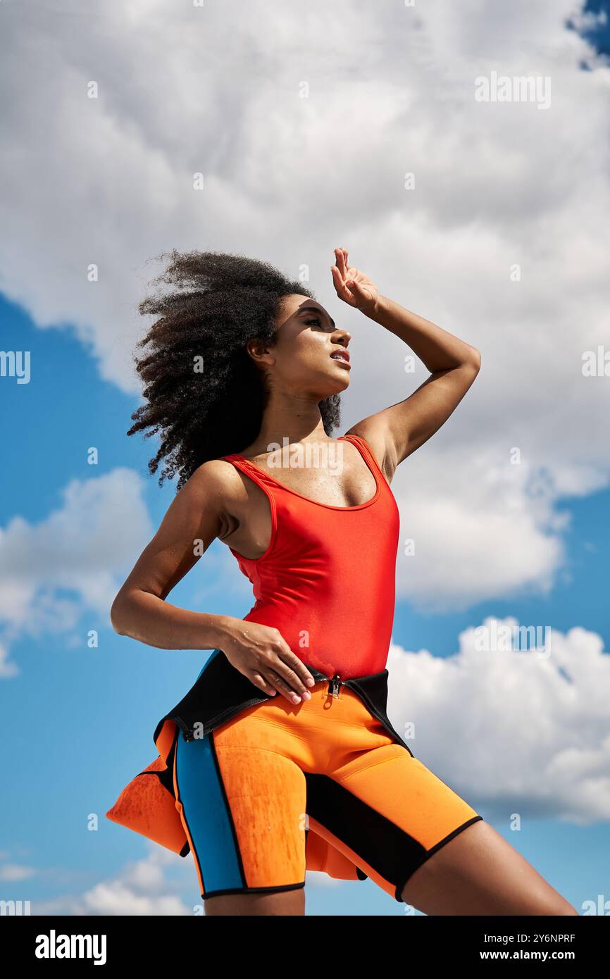 A stylish young woman poses confidently against a backdrop of vibrant ...