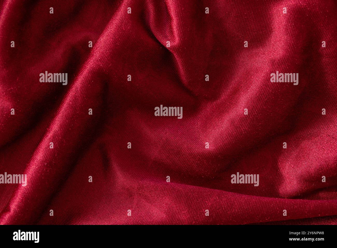 Red velvet textile folded fabric for background. Top view. Stock Photo