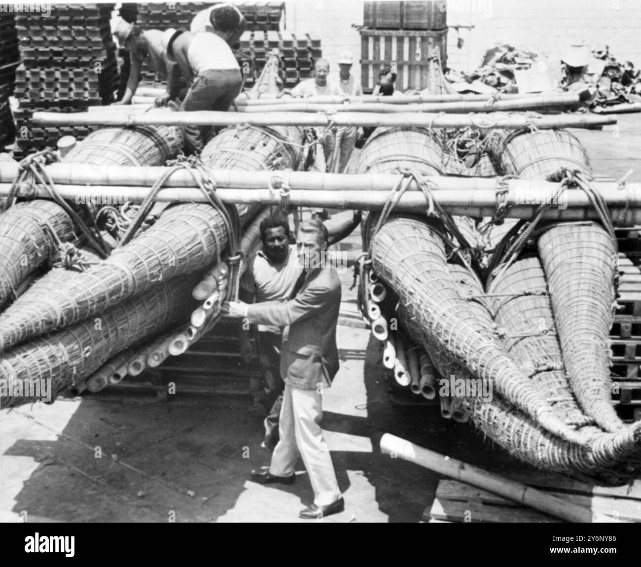 Gene Savoy on right makes a final check of his flimsy reed raft and two ...