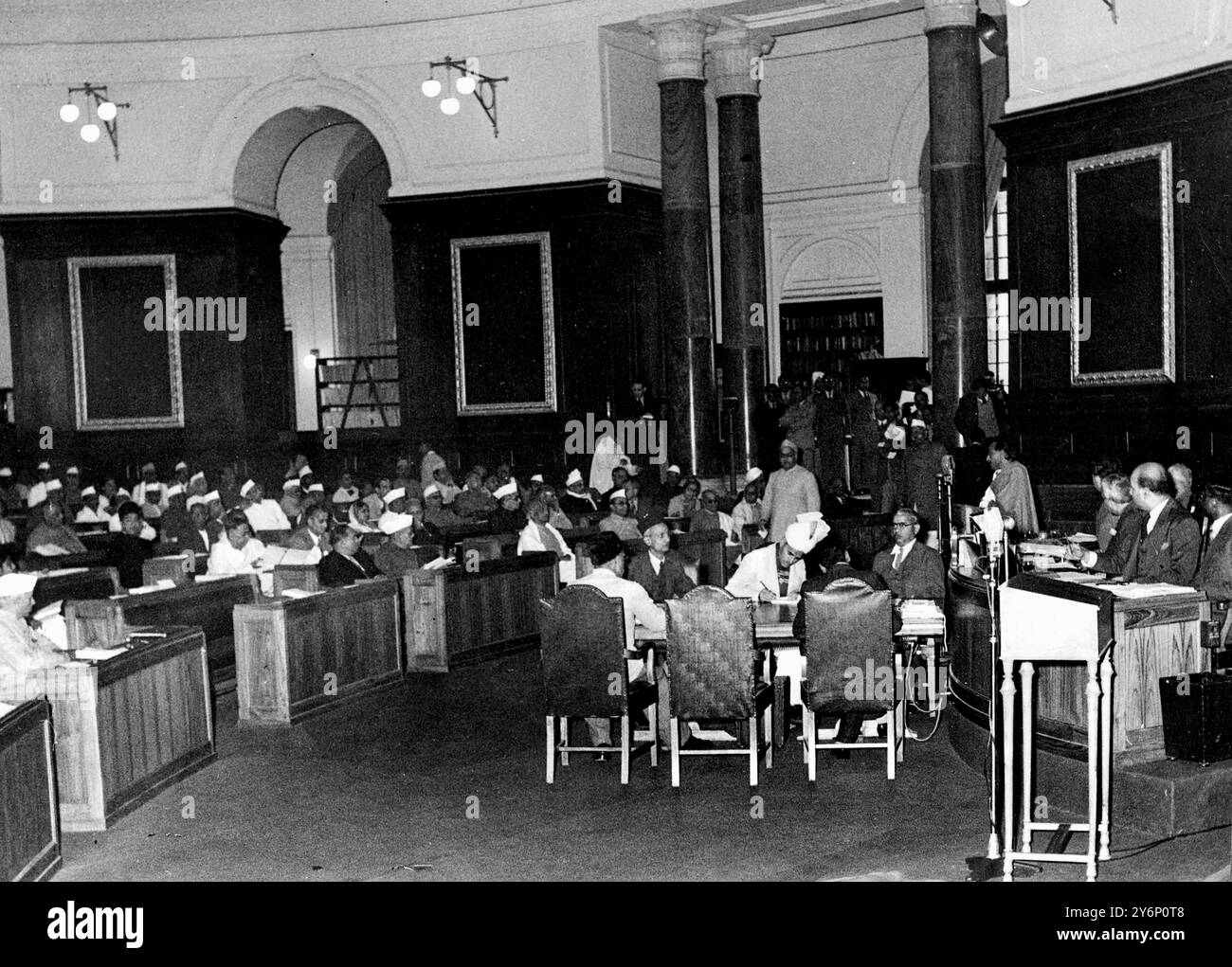 17th December 1946: The First All India Assembly in the Council House, New Delhi. Acharya Kripalani (President of the Indian National Congress) is seen standing to the right of the microphone, moving for the resolution for the election of the Provisional Chairman are, seated in the front row, l-r: Pandit Jawaharlal Nehru, Dr Amoedkar and Mr Sarat. Also attending are Chandra Bose, Sardar Patel, Mr G B Kher. Stock Photo