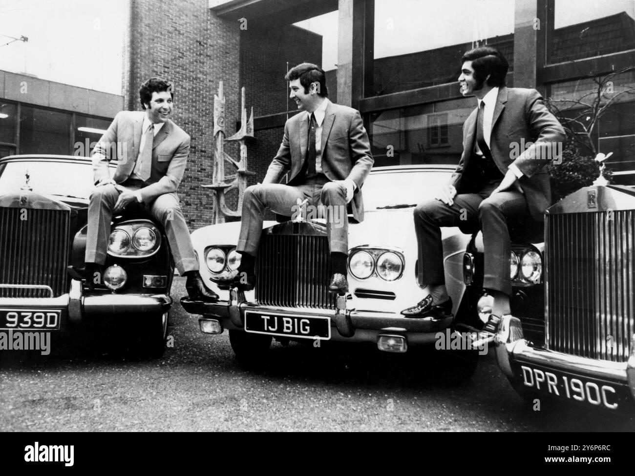 February 1969: Elstree, Herts: Singers, Tom Jones (l) and Engelbert Humperdink flank their manager, Gordon Mills astride their trio of Rolls Royces at Elstree studios, where Jones is filming his multi-million dollar American tv series. 'This is Tom Jones', which starts on ABC-TV soon. The Rolls, two Silver Shadow convertibles and a silver Cloud cost nearly $65,000. PN Stock Photo