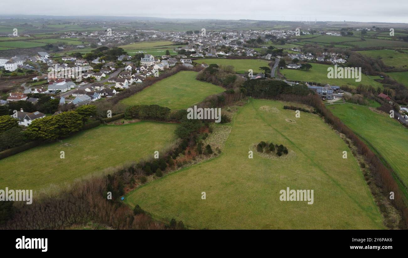 Aerial view of a small town surrounded by green fields and farmlands on ...