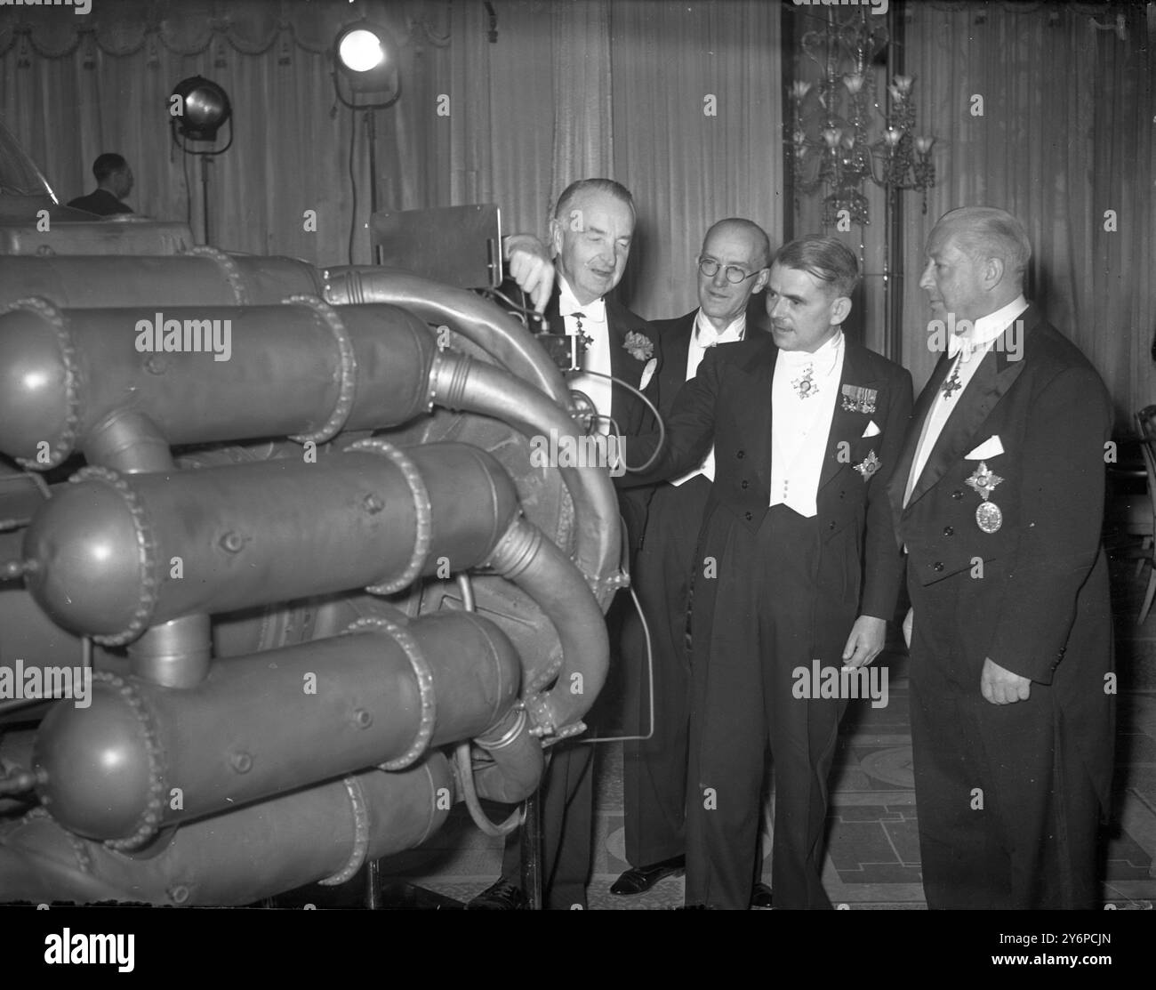 Pioneer of the jet engine were principal guests honouring the tenth anniversary of jet powered flight in the free world at a commenorative dinner at the Dorchester Hotel , London , England , attended by many of the worlds high ranking airmen . Seen here LtoR General Leon Johnson ( Commanding General , Third Air Force USAAF ); Air Commodore Sir Frank Whittle ( Pioneer designer of the jet  engine ); and General Francisco Fernandes Longoria ( Chief of the Spanish Air Forces , who reportedly turned down offers from the United States, and is enquiring about possibility of buying British jets) photo Stock Photo