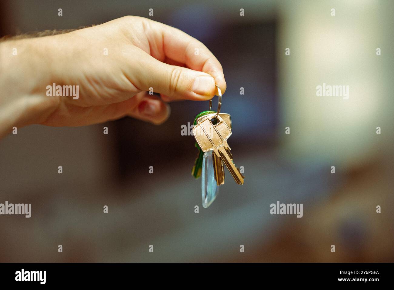Handed Keys Hand holding keys to a new house. Real estate residential. Blurred ...