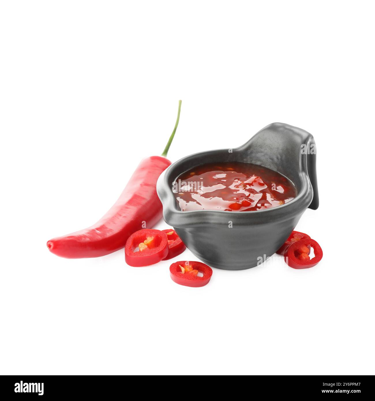 Hot chili sauce in gravy boat and pepper isolated on white Stock Photo