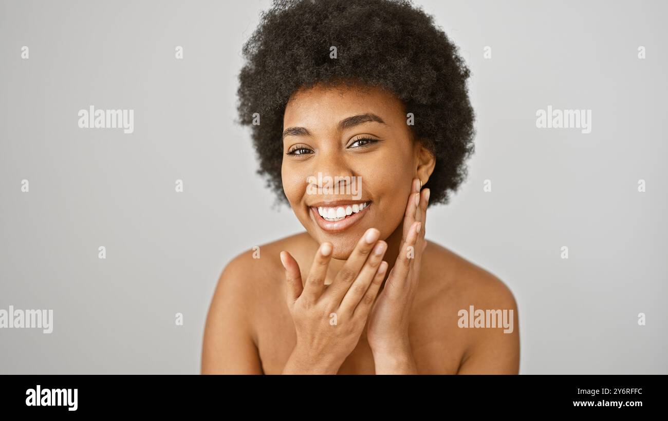 A smiling african american woman with curly hair is posing in front of ...