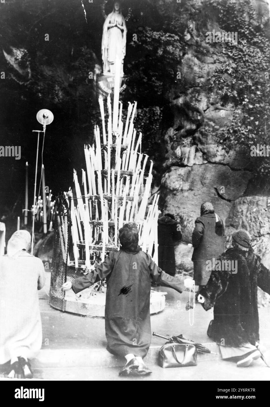 PRAYER AT GROTTO OF VIRGIN MARY LOURDES   12 MARCH 1962 Stock Photo
