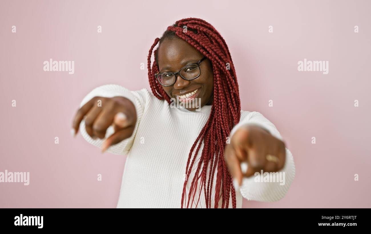 African american woman with braids smiling and pointing at camera ...