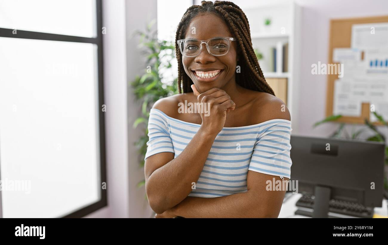 An african american woman with braids smiling confidently in a modern ...
