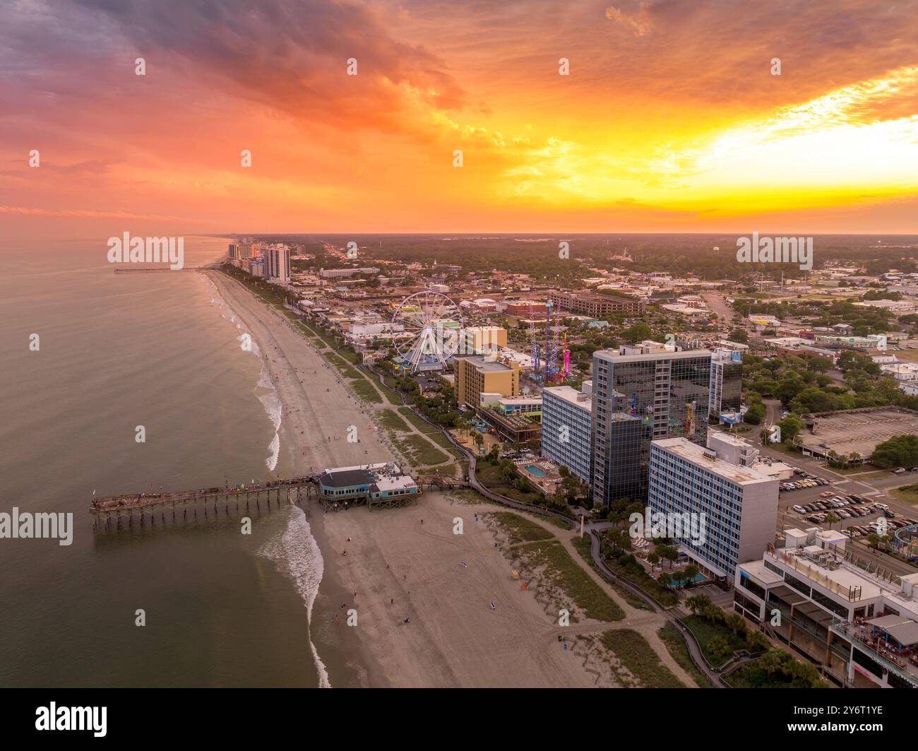 High rise hotels and beach vacation properties line the Carolina coastline on the Atlantic ocean in Myrtle beach popular in summer colorful sky Stock Photo