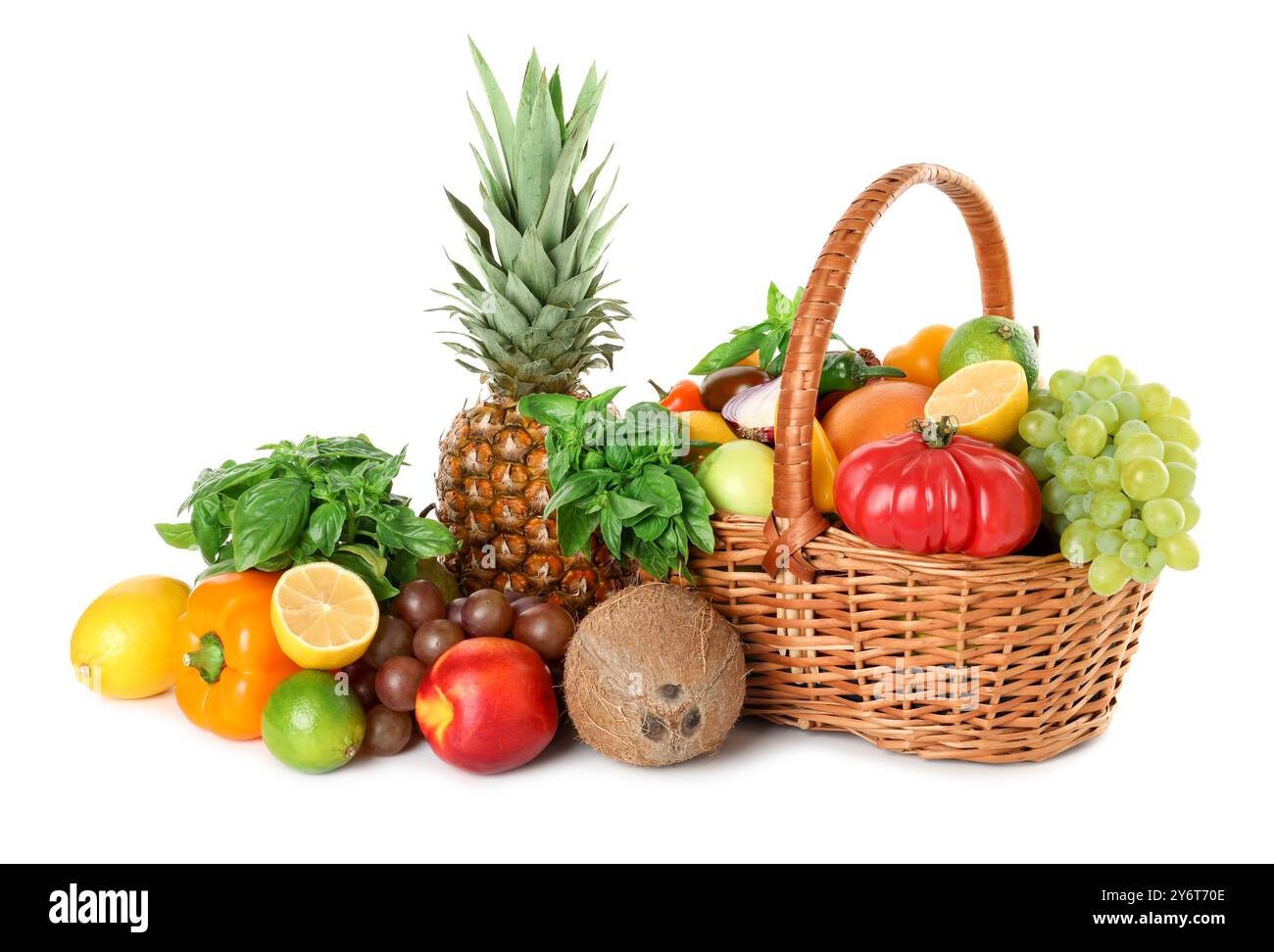 Different fresh fruits and vegetables in wicker basket isolated on ...