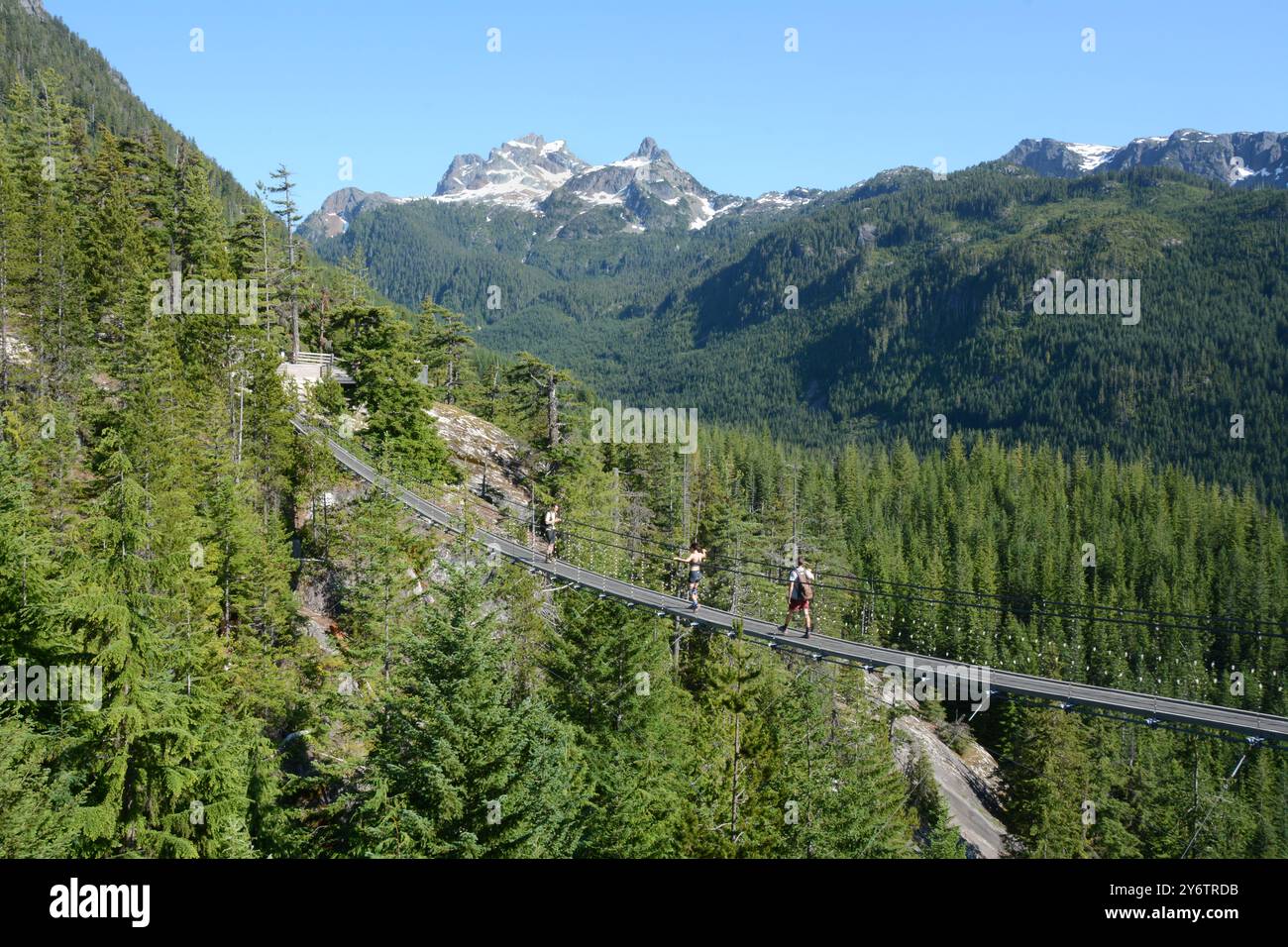 Hikers crossing the Sky Pilot Suspension Bridge in the Britannia Range of the Coast Mountains above Squamish, British Columbia, Canada. Stock Photo
