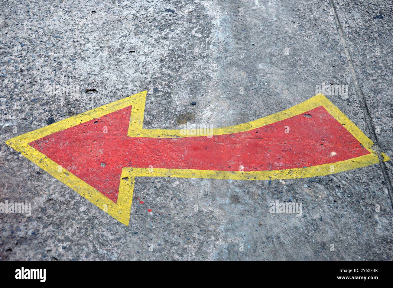red and yellow directional arrows on the cement floor Stock Photo - Alamy