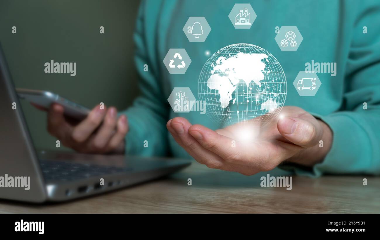 A person holding a digital globe with various technology icons ...