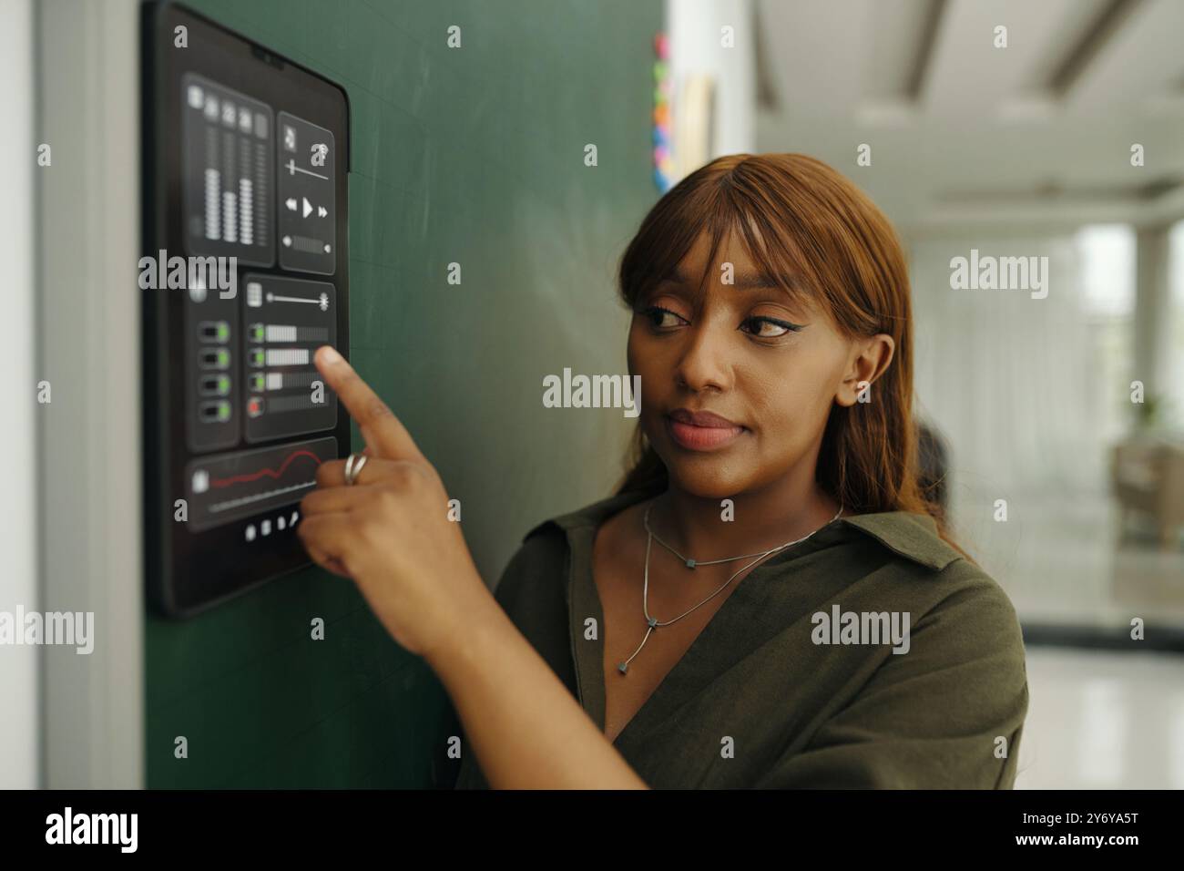 Young Woman Using Interactive Touchscreen in Office Stock Photo