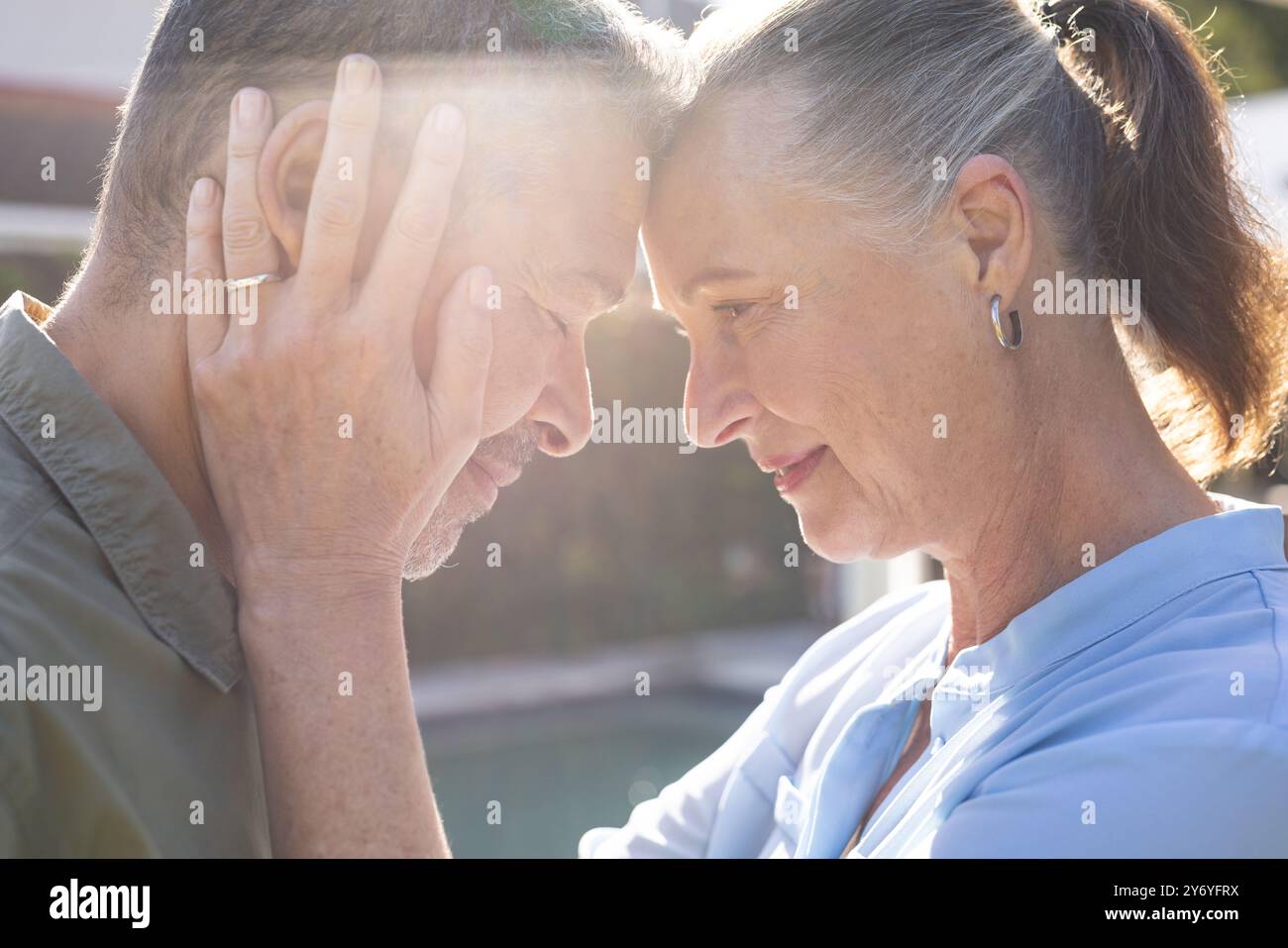 Embracing each other, senior couple sharing intimate and tender moment, at home Stock Photo