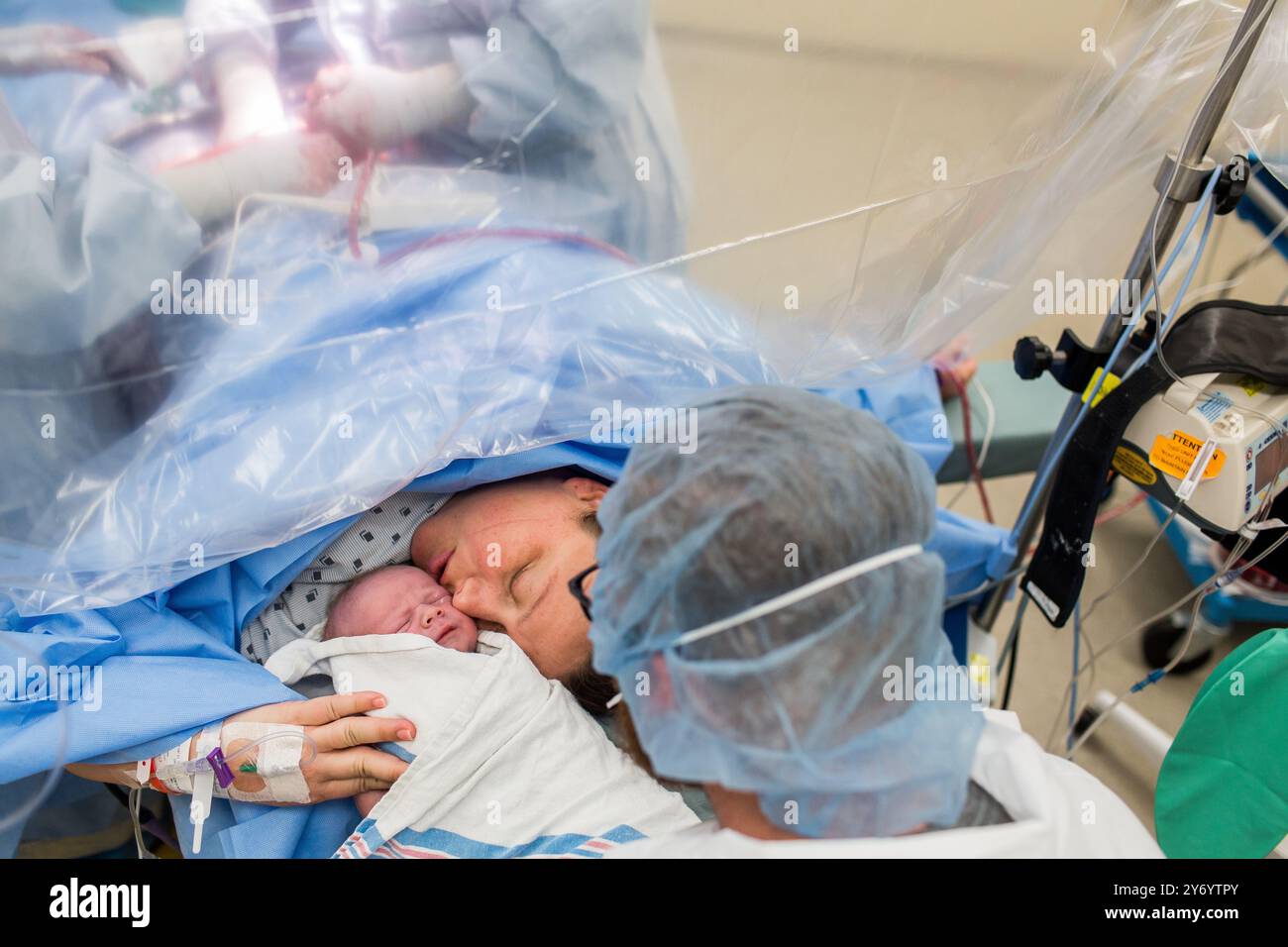 Operating Table and Mom Kissing Baby After C-Section Stock Photo - Alamy